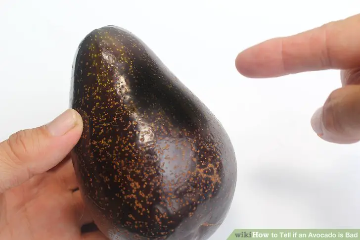 Check avocado for ripeness and look for dents